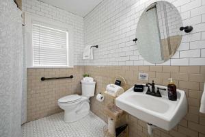 a bathroom with a sink and a toilet and a mirror at Historic Riverview Inn Two in Chattanooga