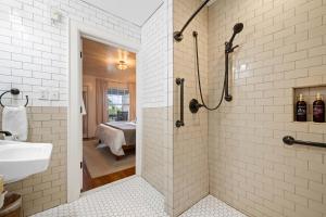 a bathroom with a shower and a sink and a bedroom at Historic Riverview Inn Two in Chattanooga