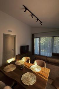 a dining room with a wooden table and chairs at Casa Mila apartments & bungalows in Ulcinj