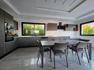 a kitchen with a table and chairs in a room at Villa Sunrise in Hammamet