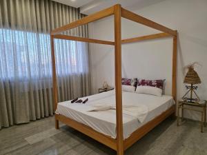a bedroom with a canopy bed and a window at Villa Sunrise in Hammamet +27 photos