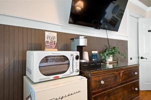 a microwave on top of a refrigerator in a kitchen at Historic Riverview Inn Four in Chattanooga
