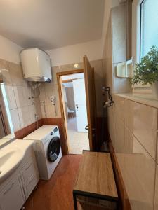 a small bathroom with a washing machine in it at Apartman with sea view KAVALA- Pašman, Kraj in Kraj +26 photos
