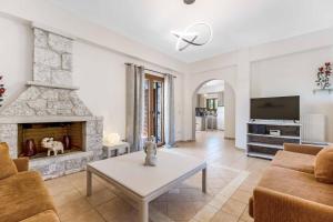 a living room with a couch and a fireplace at Villa Meli in Methoni