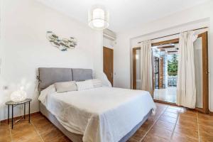 a white bedroom with a bed and a window at Villa Meli in Methoni +62 photos