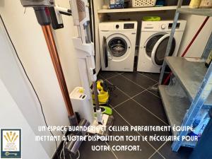 a laundry room with a washer and dryer at Les Alizés in Plouhinec