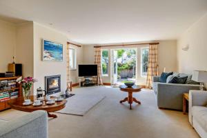 a living room with a couch and a fireplace at 5 Bed in Croyde oc-bonac in Croyde