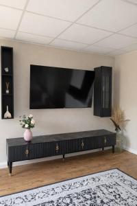 a living room with a large flat screen tv on a wall at Apartment Landglück Overath in Overath