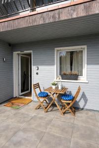 a table and two chairs sitting on a patio at Apartment Landglück Overath in Overath