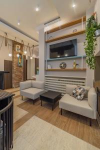 a living room with two couches and a tv at City Code InJoy RENEW in Belgrade
