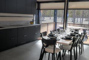 a dining room with a table with wine glasses on it at Villa Liemu, Winter season included 2 lift tickets in Äkäslompolo