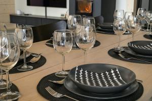 a table with wine glasses and a plate on it at Villa Liemu, Winter season included 2 lift tickets in Äkäslompolo +53 photos