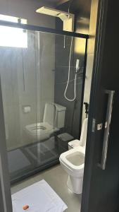 a bathroom with a glass shower and a toilet at Sunrise in Domingos Martins +21 photos