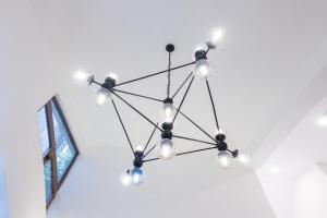 a chandelier hanging from a ceiling in a room at Colonial studio with 2 Beds - Patio Español in Santo Domingo