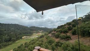 a view of a hill with trees and a valley at Sunrise in Domingos Martins
