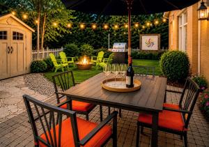 a wooden table with a bottle of wine and chairs at Downtown Picton Retreat - Near Sandbanks and Wineries in Picton