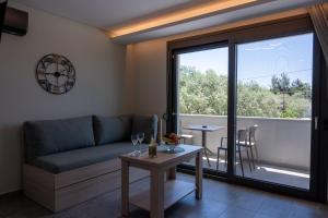 a living room with a couch and a table at Psarras Deluxe Suites in Limenas