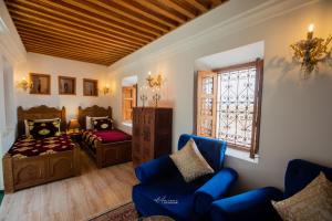 a living room with a bed and a couch at Riad el Fenna 1974 in Chefchaouen +64 photos