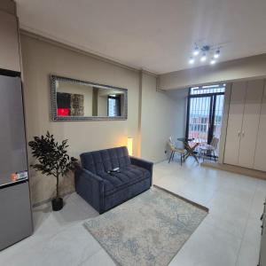 a living room with a couch and a mirror at Dana Residence in Floreşti