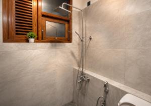 a bathroom with a shower with a toilet and a sink at Araliya Hotel in Badulla +29 photos