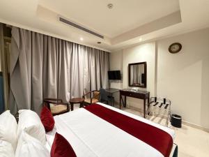 a hotel room with a bed and a desk at Akarem New - Al Safa - اكــارم - الصفا in Jeddah