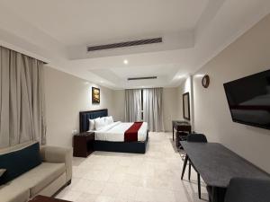 a hotel room with a bed and a couch at Akarem New - Al Safa - اكــارم - الصفا in Jeddah +56 photos