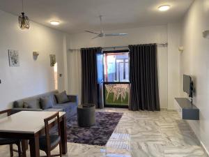a living room with a couch and a table at pure peace hotel in Luxor