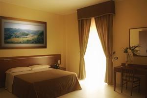 Postel nebo postele na pokoji v ubytování Hotel Ruffirio