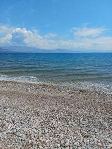 a rocky beach with the ocean in the background at Valimitika beach house - Just 150m from the beach in Valimítika +2 photos