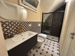 a bathroom with a toilet and a sink and a shower at Cà di Righe in Pietra Ligure +21 photos