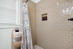 a shower with a shower curtain in a bathroom at Historic Riverview Inn Three in Chattanooga