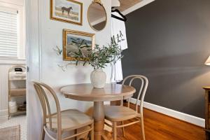 a dining room table with chairs and a vase with a plant at Historic Riverview Inn Three in Chattanooga
