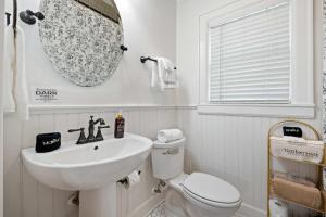 a white bathroom with a sink and a toilet at Historic Riverview Inn Three in Chattanooga