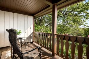 a porch with a chair and a table on it at Historic Riverview Inn Three in Chattanooga +21 photos