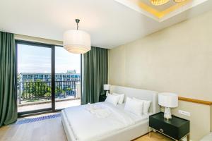 a bedroom with a bed and a large window at FS The Grand Sea Breeze in Baku +47 photos