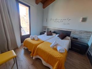 a bedroom with two beds with towels on them at Casa Rural Tarayuela in Cantavieja