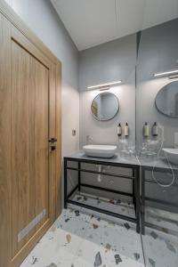 a bathroom with a sink and a wooden door at City Code InJoy RENEW in Belgrade +76 photos