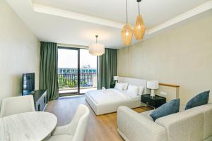 a bedroom with a bed and a living room at FS The Grand Sea Breeze in Baku