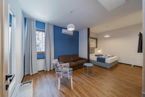 a living room with a couch and a bed at City Code InJoy RENEW in Belgrade