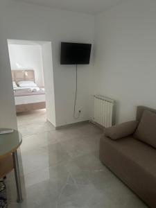 a living room with a couch and a bed at UROS apartments in Boreti
