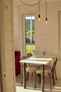 a dining room with a white table and chairs at Runa House in Verkhovyna +9 photos