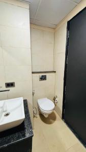 a bathroom with a white toilet and a sink at Moon escape studio in Ghaziabad +9 photos