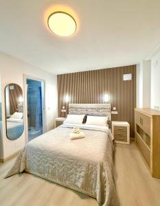 a bedroom with a bed with two towels on it at Alteagroup Joy in Altea