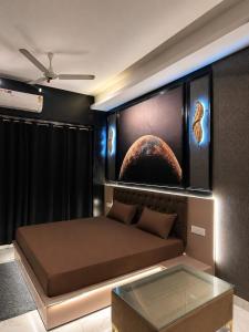 a bedroom with a bed with a planet mural on the wall at Moon escape studio in Ghaziabad