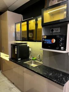 a kitchen with a sink and a microwave at Moon escape studio in Ghaziabad