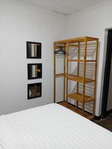 a bedroom with a bed and a book shelf at Ntinti Stays Cottage in Ndola
