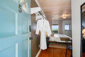 a white robe hanging on a door in a bedroom at Historic Riverview Inn Five in Chattanooga