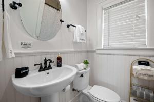 a bathroom with a sink and a toilet and a mirror at Historic Riverview Inn Five in Chattanooga