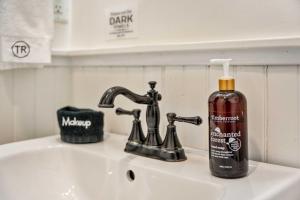 a bottle of soap sitting on top of a sink at Historic Riverview Inn Five in Chattanooga +25 photos