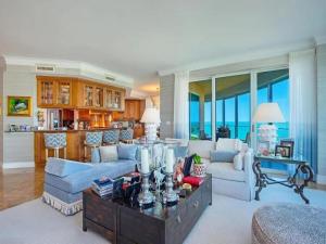 a living room with a couch and a table at Beachfront Elegance Escape in Naples